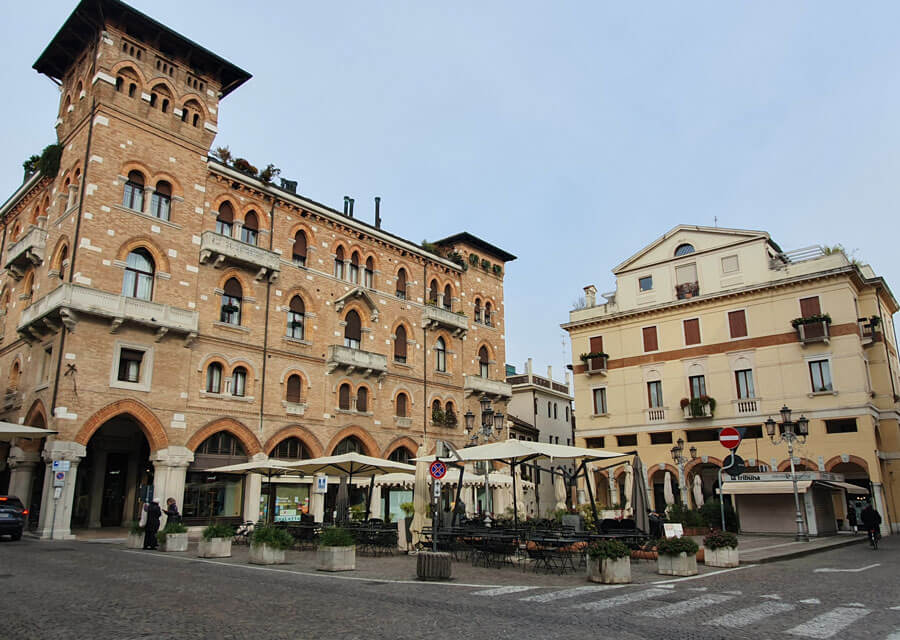 Buildings and café tables in Piazza San Vito in Treviso, Italy