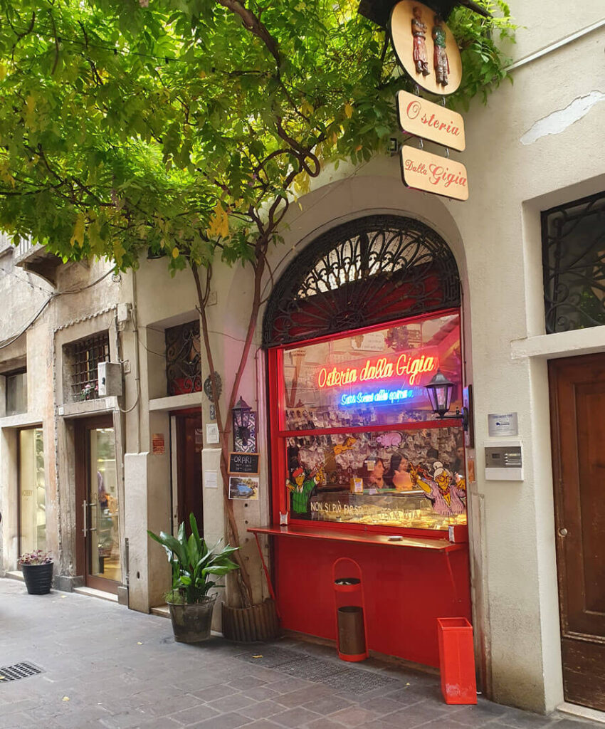 Illuminated window and sign of the Osteria dalla Gigia